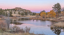 Serene Lake with Autumn Foliage and Pastel Pink Sky