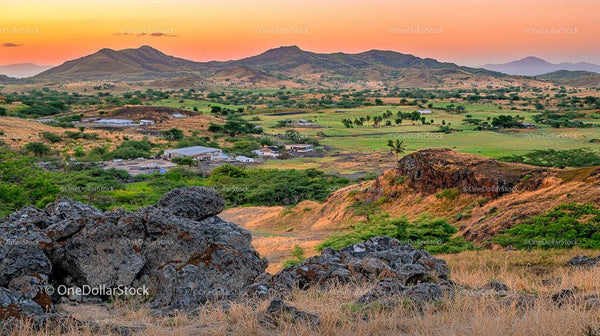 Scenic Sunset Over Lush Valley and Rolling Hills