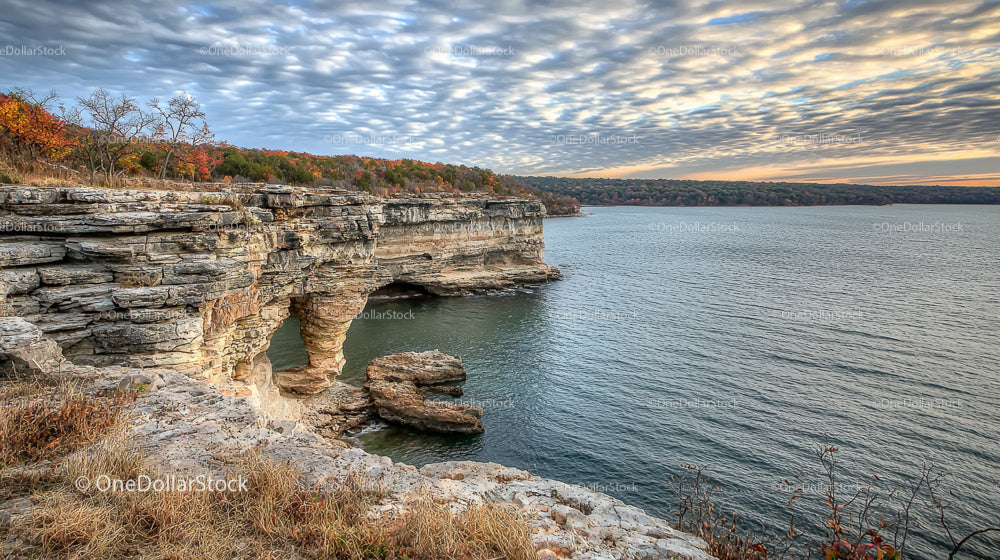 Dramatic Cliffside Overlooking a Serene Body of Water