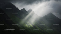 Dramatic Mountain Peaks Under Misty Clouds
