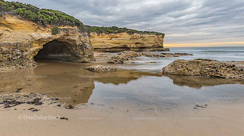 Dramatic Sea Cave and Rocky Coastline at Sunset