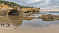 Dramatic Sea Cave and Rocky Coastline at Sunset
