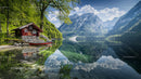 Serene Alpine Lake with Red Cabin and Mountain Views