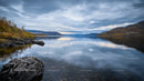 Tranquil Lake with Autumn Trees and Rocky Shores