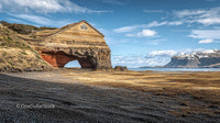 Rugged Coastal Rock Formation Under a Vast Blue Sky