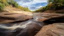 Rocky Gorge with Flowing River and Autumn Foliage