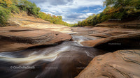 Rocky Gorge with Flowing River and Autumn Foliage