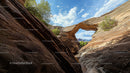 Majestic Natural Arch in Desert Canyon with Clear Blue Sky