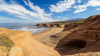 Majestic Coastal Cliffs and Sandy Beaches Under Clear Blue Skies