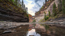 Scenic Canyon and River Reflection Under Cloudy Skies