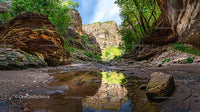 Scenic Rocky Canyon with Serene Water Reflection