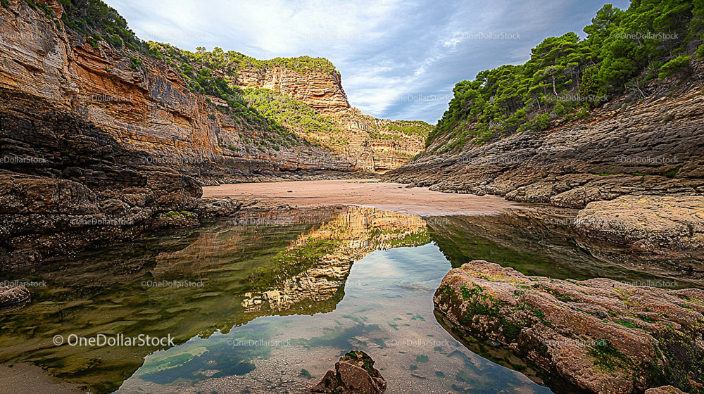 Tranquil Cove with Reflective Waters and Verdant Cliffs