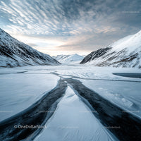 Breathtaking View of Snow-Capped Mountains and Frozen Lake