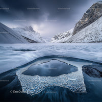 Frozen Mountain Landscape with Ice Formations and Snowy Peaks