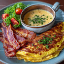 Gourmet Breakfast with Bacon, Omelet, and Creamy Soup