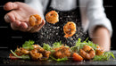 Chef Preparing Gourmet Shrimp with Fresh Herbs and Spices