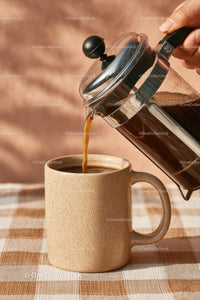 Pouring Fresh Coffee from French Press into Ceramic Mug
