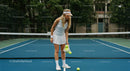 Female Tennis Player Preparing for Serve on Court