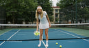 Young Woman Playing Tennis on Outdoor Court