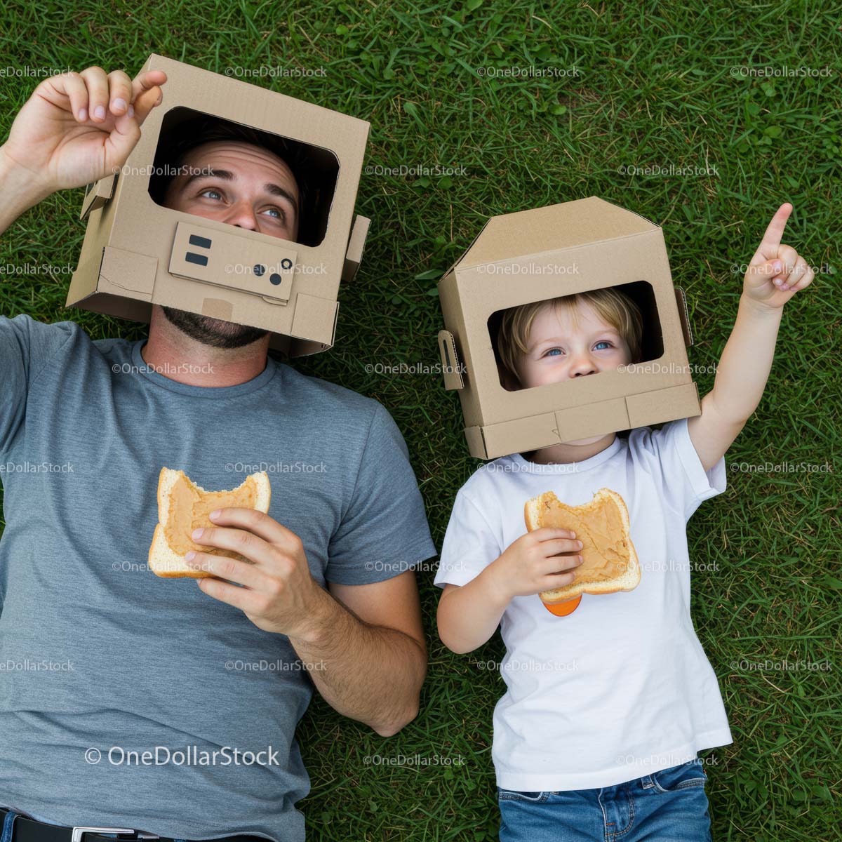 Father and Son Playing with Cardboard Helmets on Grass