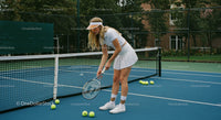 Young Woman Practicing Tennis on Outdoor Court