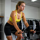 Woman Focused on Intense Indoor Cycling Workout