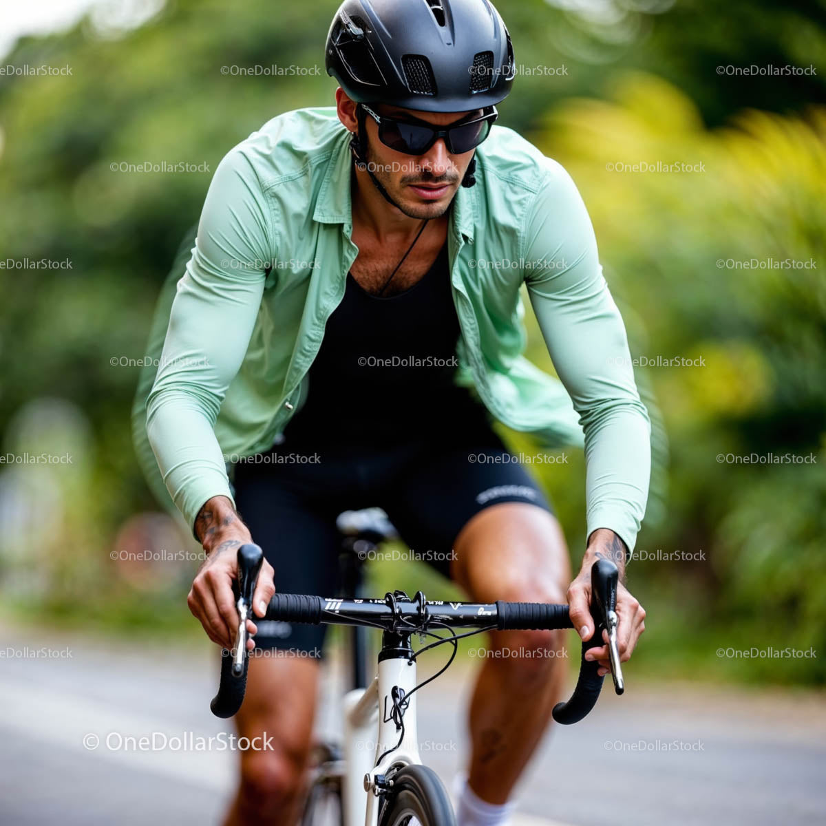 Male Cyclist Riding on a Scenic Road in Summer