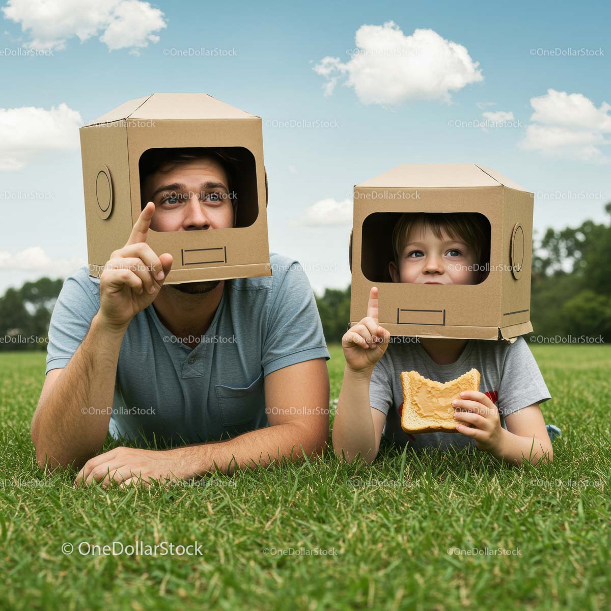 Father and Son Playing with Cardboard Box Helmets Outdoors