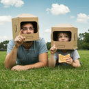Father and Son Playing with Cardboard Box Helmets Outdoors