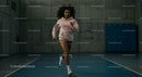 Athletic Woman Running in Indoor Gym Setting