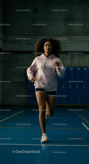 Focused Woman Running on Indoor Blue Sports Court