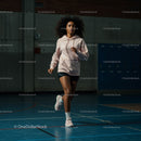 Athletic Woman Running on Indoor Track in Sportswear