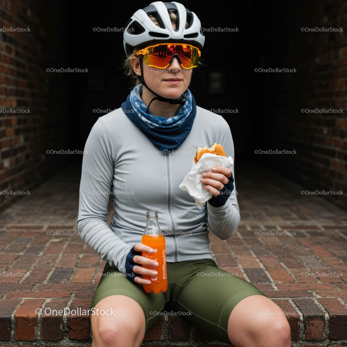 Woman Cyclist Enjoying Snack Break in Urban Surrounding