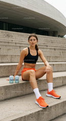 Athletic Woman Taking a Break on Concrete Steps