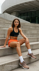 Athletic Woman in Sporty Outfit Resting on Urban Stairs
