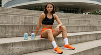 Athletic Woman Resting on Concrete Steps After Workout