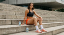 Athletic Woman Relaxing on Urban Concrete Steps