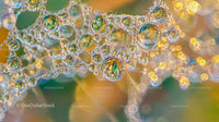 Dew-Covered Spider Web with Vibrant Reflections