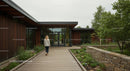 Modern Office Building with Wooden Exterior and Lush Garden