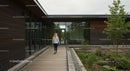 Modern Office Building with Wooden Exterior and Lush Garden