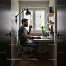 Man Enjoying Coffee While Working in a Modern Home Office