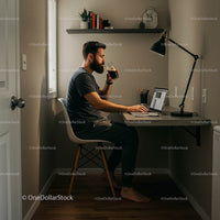 Man Working in Minimalist Home Office with Laptop and Coffee