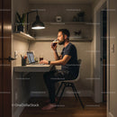 Man Working in Cozy Home Office with Drink in Hand