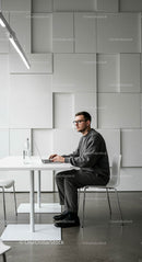 Man Working on Laptop in Minimalist Modern Office