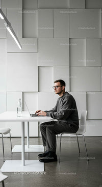 Man Working on Laptop in Minimalist Modern Office