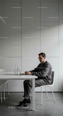 Focused Man Working on Laptop in Minimalist Office