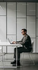 Professional Man Working on Laptop in Modern Office