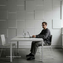 Young Man Working on Laptop in Modern Minimalist Office