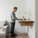 Man Working on Laptop at Standing Desk in Modern Interior