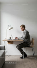Minimalist Home Office with Man Working at Laptop
